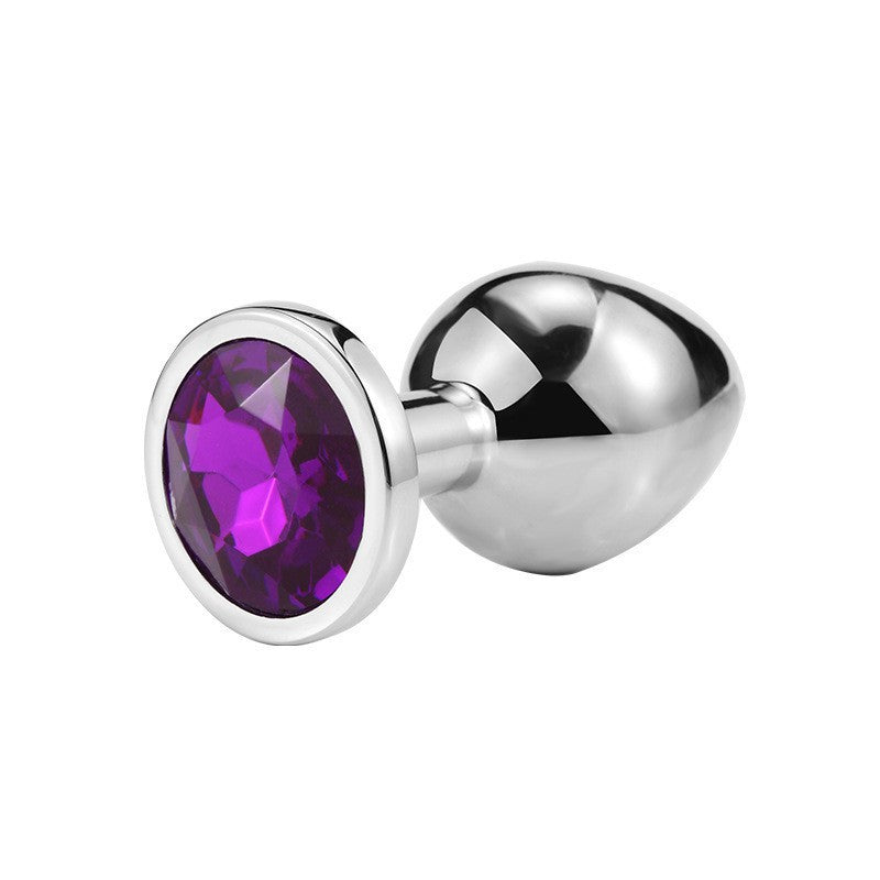 Round jeweled metal plug with deep purple jewel