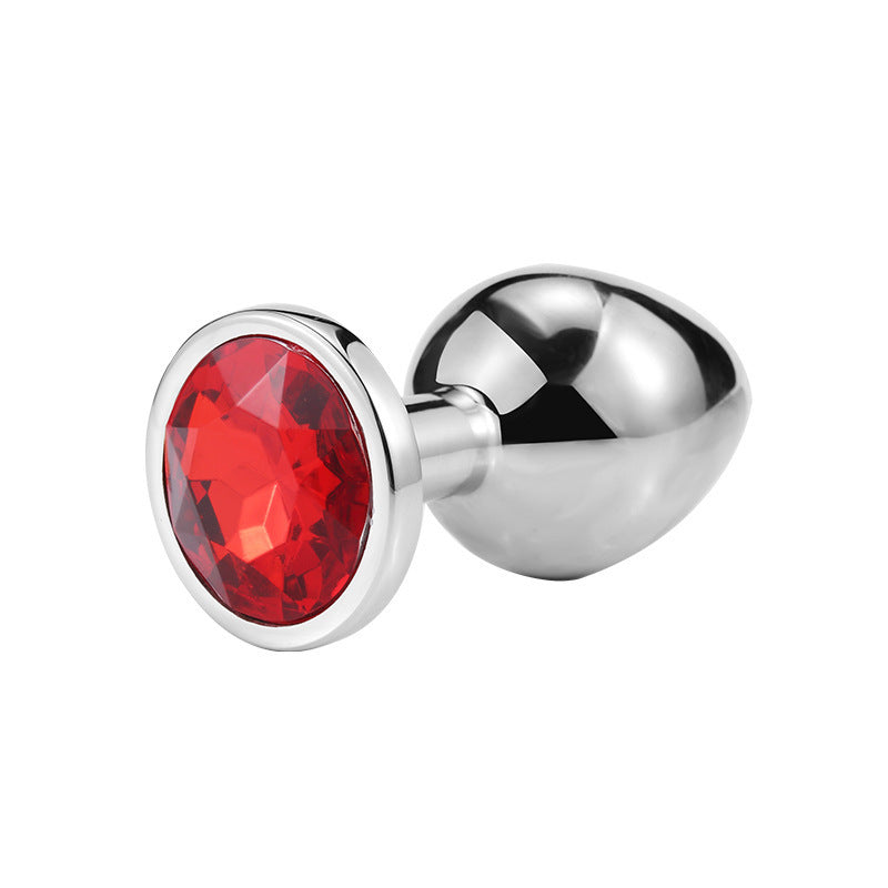 Round jeweled metal plug with red jewel